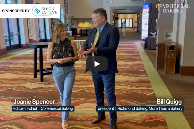 Bill Quigg and Joanie Spencer walking and talking at an event.