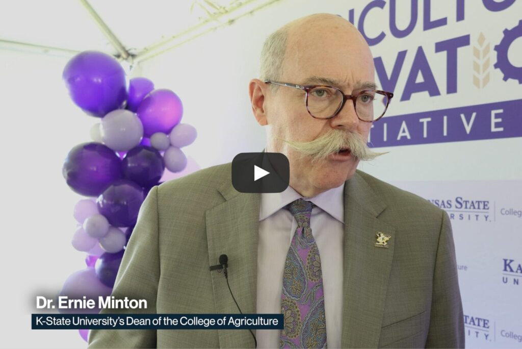 Dr. Ernie Minton, Dean of the College of Architecture at KSU, standing in front of a purple backdrop at the Agriculture Innovation Initiative groundbreaking ceremony.