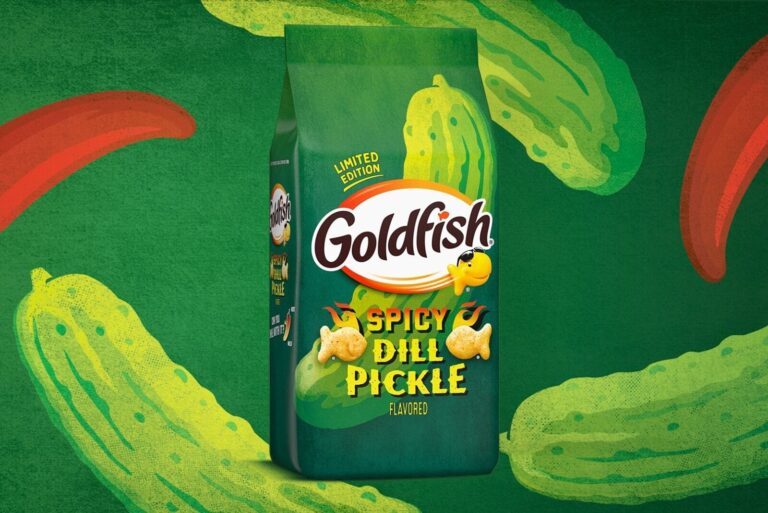 Package of Spicy Dill Pickle Goldfish on pickle background.