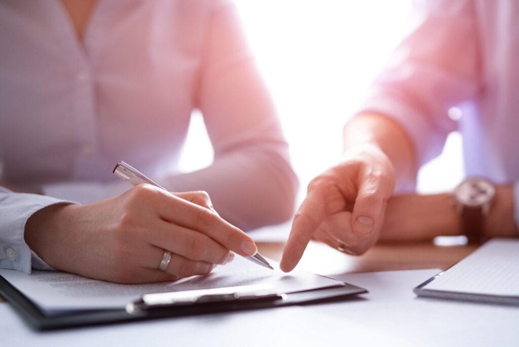 Two people working on a document together.