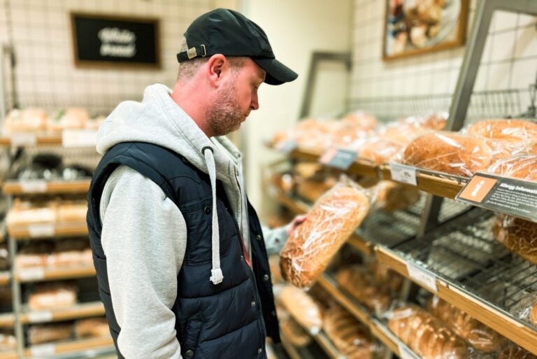 Man looks at bread in bakery section