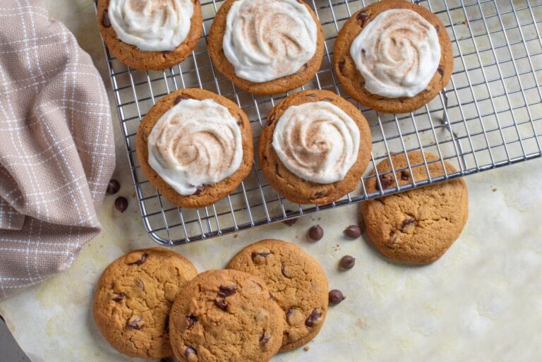 Otis Spunkmeyer Pumpkin Spice Chocolate Chip Cookies on light-colored counter and wire rack