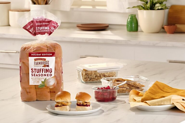 Package of rolls on counter with turkey and cranberry around it.