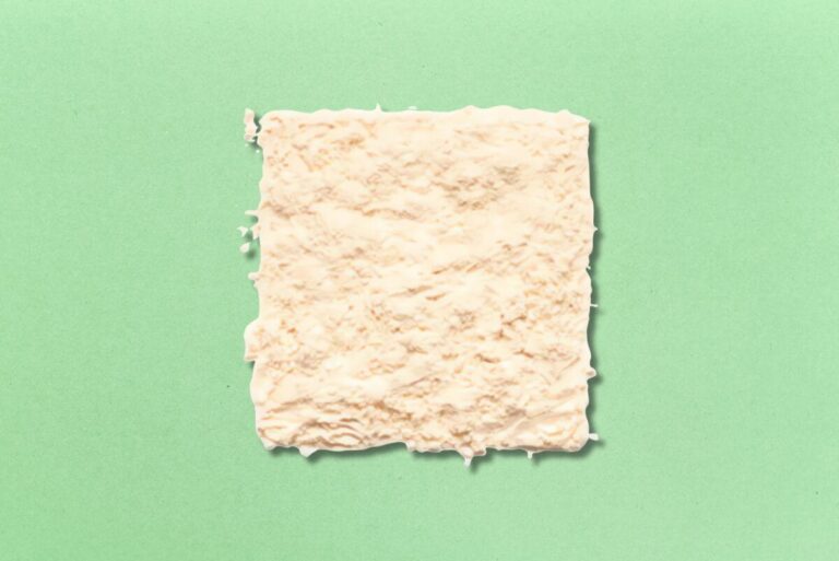 Block of Grain Millers' Oat Fiber on gradient green background.