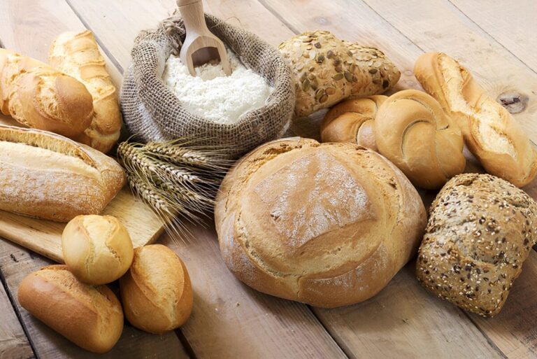 Variety of bread and bread loaves on table.