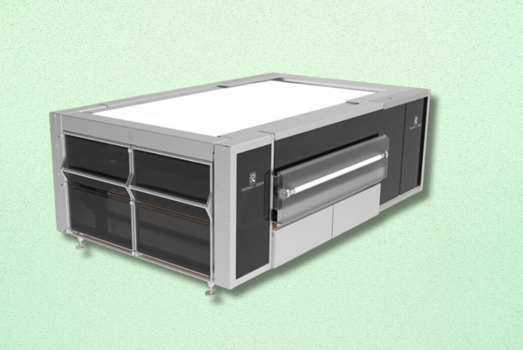 Reading Bakery Systems' laminator on gradient green background.