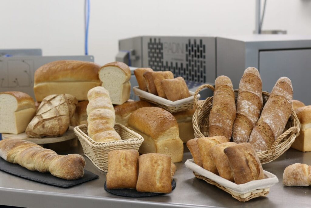 Multiple loaves of bread on table.