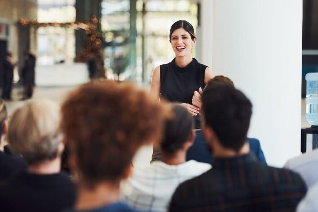 Woman in black shirt speaking to team, Guidance on building a flexible workforce