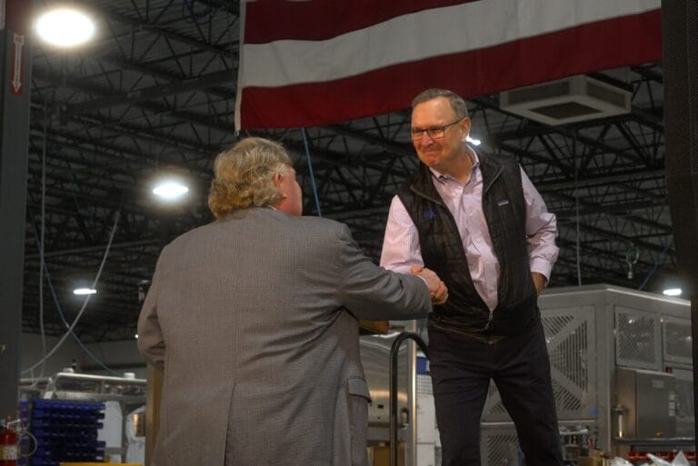 Craig Souser, president and CEO of JLS, shaking hands with person
