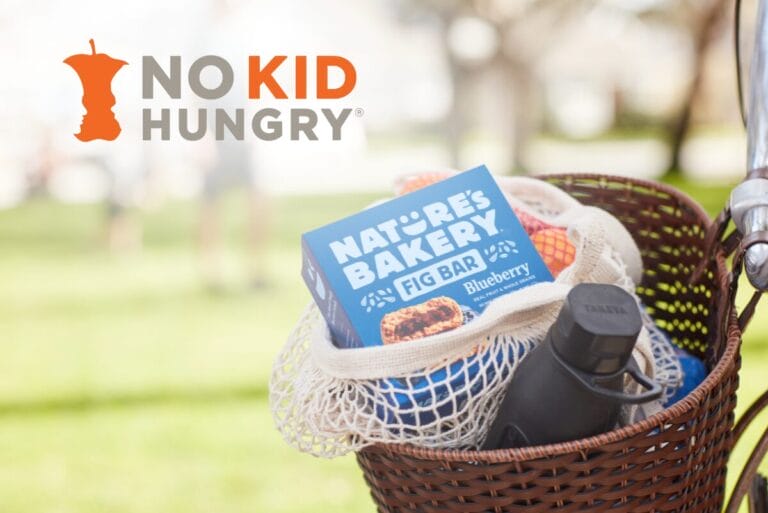 No Kid Hungry in top left corner of image with Nature's Bakery box in basket of bicycle