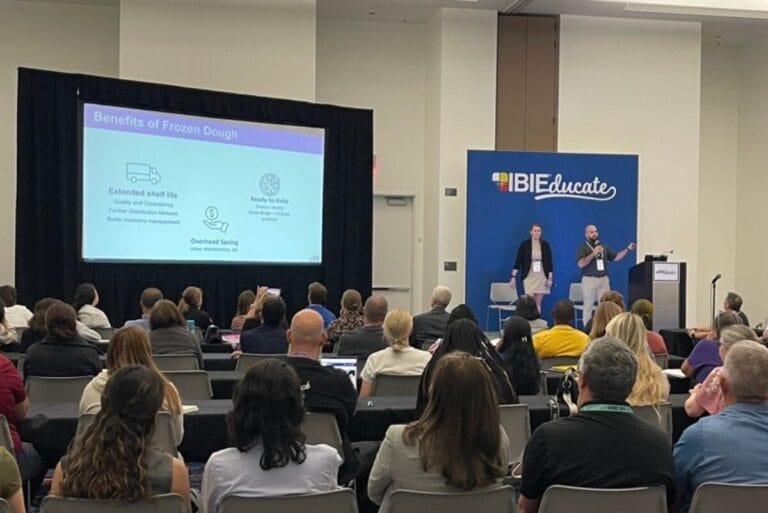 People presenting on quality factors of dough at IBIE 2025