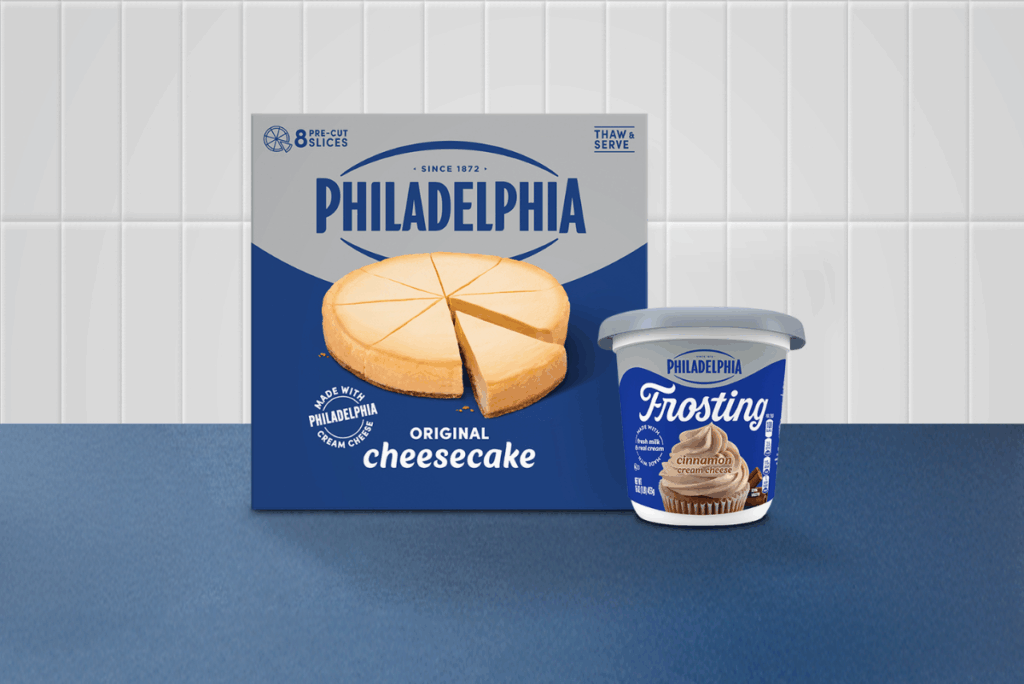 Philadelphia Cream Cheese Frozen Cheesecake and Cinnamon Frosting on blue countertop with white tile background