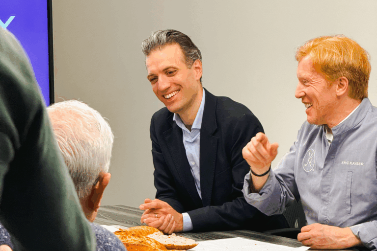 Alexander de Salameh sitting at a table with Bakery de France team members