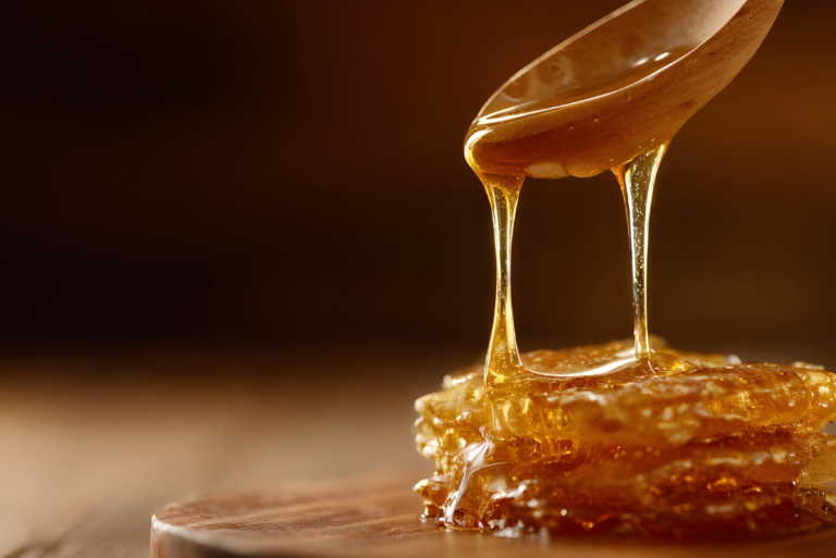 Spoon dripping syrup onto counter