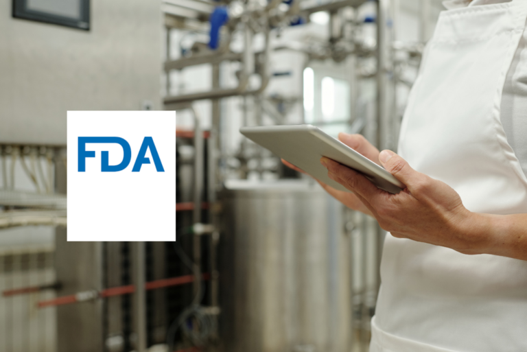FDA logo next to someone holding tablet in manufacturing plant