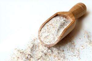 wooden scoop on a pile of flour