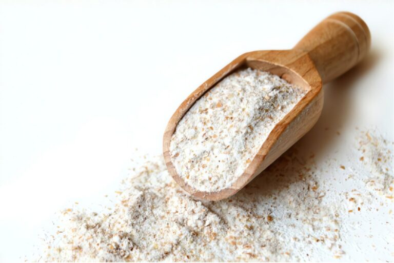 wooden scoop on a pile of flour