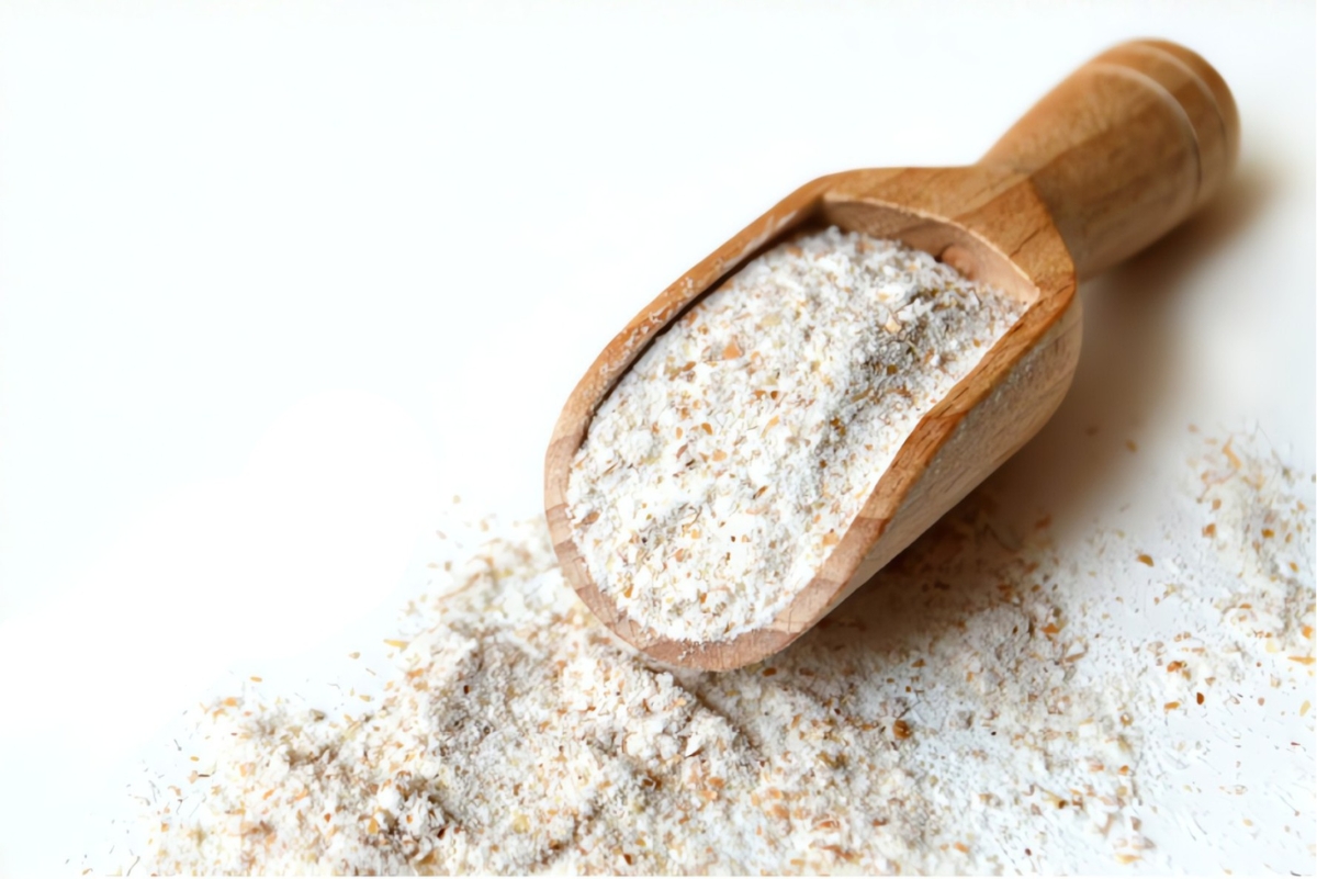 wooden scoop on a pile of flour