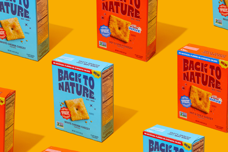 Back to Nature White Chedda and Hot & Spicy boxes laid out in grid over orange background