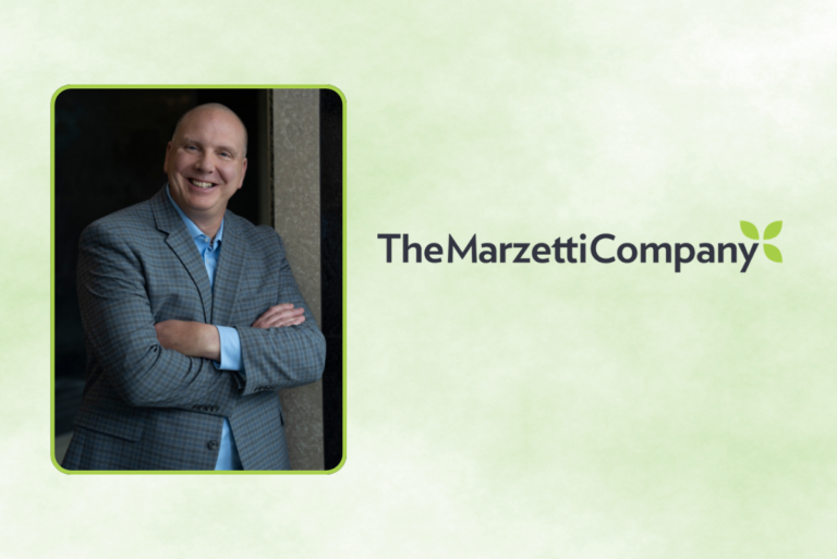 Image of Mark Carter in grey suit and blue shirt with The Marzetti Co. logo over green background