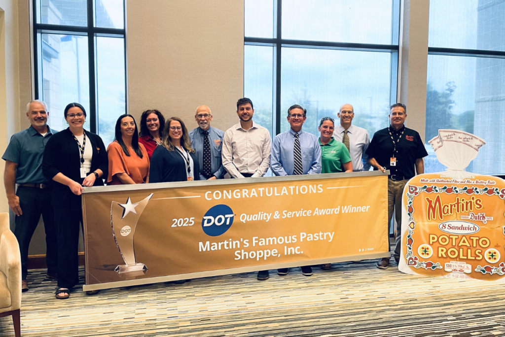 Martin's Famous Pastry Shoppe team members with sign celebrating Dot Foods recognition
