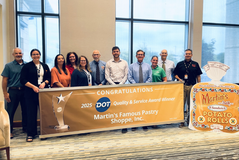 Martin's Famous Pastry Shoppe team members with sign celebrating Dot Foods recognition