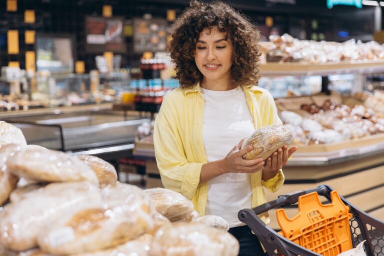 Consumer buying healthy bread at grocery store